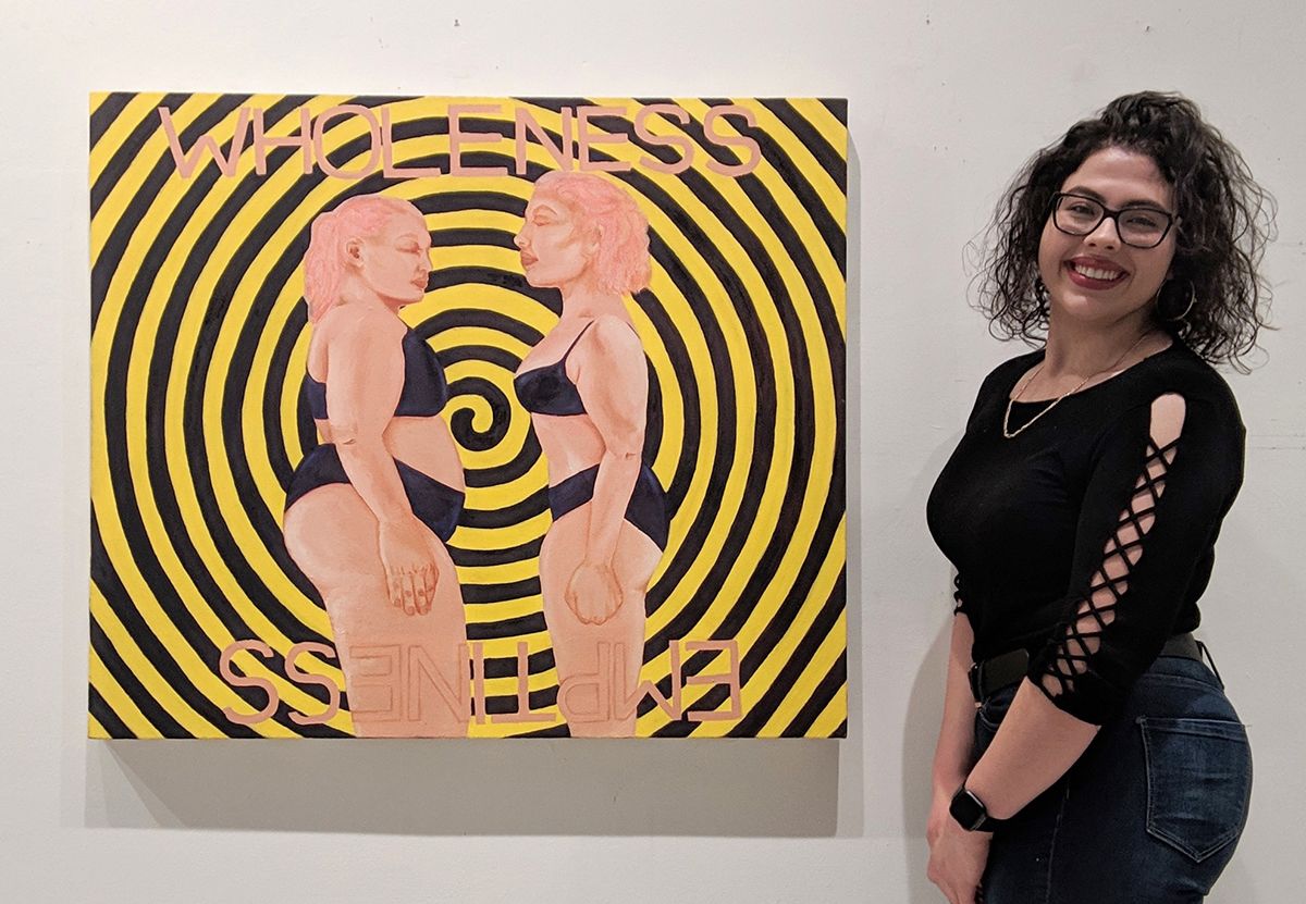 Colette next to a piece of artwork