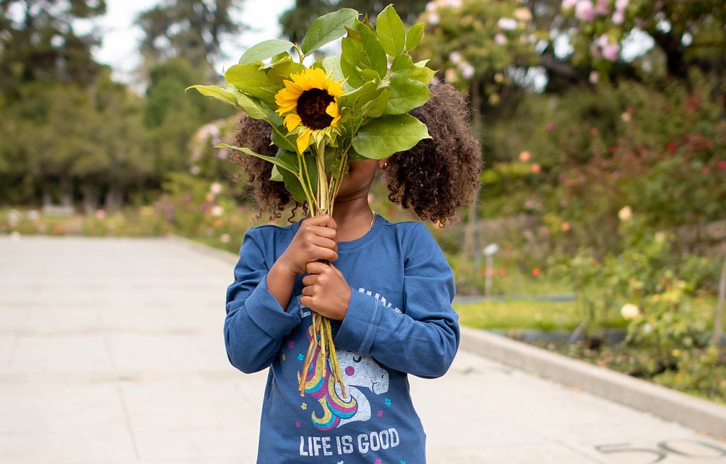 Daughter holding sunflower